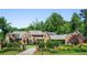 Charming brick home featuring meticulously maintained greenery, an iron gate, and a circular drive, creating a picturesque scene at 4520 Garmon Nw Rd, Atlanta, GA 30327