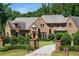 Elegant brick home with manicured landscaping, gated entrance, and a winding driveway for a stately and welcoming curb appeal at 4520 Garmon Nw Rd, Atlanta, GA 30327