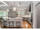 Modern kitchen with grey cabinetry, stainless steel appliances, an island with seating, and hardwood floors at 4520 Garmon Nw Rd, Atlanta, GA 30327
