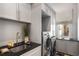 Well-organized laundry room with modern washer and dryer, ample storage, and a convenient utility sink at 4520 Garmon Nw Rd, Atlanta, GA 30327