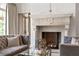 Cozy living room featuring stone fireplace, neutral decor, and ample seating at 4520 Garmon Nw Rd, Atlanta, GA 30327