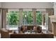 Elegant living room with plush seating, French doors opening to the backyard, and natural light at 4520 Garmon Nw Rd, Atlanta, GA 30327