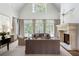 Bright living room with high ceilings, stone fireplace, and expansive windows overlooking outdoors at 4520 Garmon Nw Rd, Atlanta, GA 30327