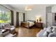 Light-filled main bedroom boasts hardwood floors, sitting area, and large windows at 4520 Garmon Nw Rd, Atlanta, GA 30327