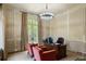 Home office showcasing wood-paneled walls, a modern chandelier, and French doors leading to the outside at 4520 Garmon Nw Rd, Atlanta, GA 30327