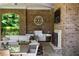 Covered outdoor patio featuring an outdoor kitchen, fireplace, and comfortable seating area for entertaining at 4520 Garmon Nw Rd, Atlanta, GA 30327