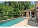 Inviting backyard pool area with brick patio, outdoor seating, and views of mature trees at 4520 Garmon Nw Rd, Atlanta, GA 30327