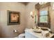Elegant powder room with marble countertop, bowl sink, and decorative accents at 4520 Garmon Nw Rd, Atlanta, GA 30327