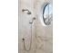 Close up of a modern shower with marble tiling and a unique circular window at 4520 Garmon Nw Rd, Atlanta, GA 30327
