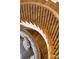 Elegant curved staircase with wood treads, iron railings, and a comfortable seating area beneath it at 4520 Garmon Nw Rd, Atlanta, GA 30327