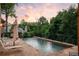 Inviting swimming pool with stone surround and metal fence offering a serene space for relaxation and outdoor enjoyment at 4520 Garmon Nw Rd, Atlanta, GA 30327