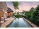 Backyard infinity pool with lounge chairs, serene landscaping, and twilight colors making it ideal for relaxation and entertainment at 4520 Garmon Nw Rd, Atlanta, GA 30327