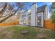 View of back of house with patio and a fenced yard at 1074 Wenham Ln, Lawrenceville, GA 30044