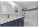 Stylish bathroom featuring double sinks, a modern vanity, and tiled shower and tub at 1074 Wenham Ln, Lawrenceville, GA 30044