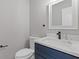 Modern bathroom with a blue vanity, white marble countertop, and sleek fixtures at 1074 Wenham Ln, Lawrenceville, GA 30044