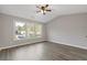 Bright and airy bedroom with hardwood floors and natural light from multiple windows at 1074 Wenham Ln, Lawrenceville, GA 30044