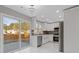 Modern kitchen featuring white cabinets, stainless steel appliances, and a sliding glass door at 1074 Wenham Ln, Lawrenceville, GA 30044