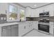 Bright kitchen with white cabinets, stainless steel appliances, and sleek countertops at 1074 Wenham Ln, Lawrenceville, GA 30044