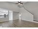 Open-concept living room with hardwood floors and views into the modern kitchen at 1074 Wenham Ln, Lawrenceville, GA 30044