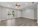 Bright living room featuring hardwood floors, modern lighting, and a large window for ample natural light at 1074 Wenham Ln, Lawrenceville, GA 30044