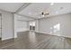 Bright living room featuring hardwood floors, modern lighting, and large windows for ample natural light at 1074 Wenham Ln, Lawrenceville, GA 30044