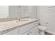 Bathroom boasts a granite countertop, white cabinets, and modern fixtures for a sleek and functional design at 167 Belldown Ct, Mcdonough, GA 30253