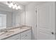 Bathroom featuring double sinks, granite countertops, and a large mirror at 167 Belldown Ct, Mcdonough, GA 30253