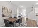 A dining room features modern decor, including a wood table and accent rug at 167 Belldown Ct, Mcdonough, GA 30253