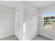 Walk-in closet with installed shelving and natural light from the window at 167 Belldown Ct, Mcdonough, GA 30253