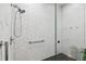 Tiled shower area featuring a rainfall shower head, safety grab bar, and frameless glass door at 3630 Peachtree Ne Rd # 3302, Atlanta, GA 30326