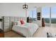 Bright bedroom with large windows offering scenic views, hardwood floors, and a padded headboard at 3630 Peachtree Ne Rd # 3302, Atlanta, GA 30326