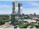 Modern high-rise building with reflective glass facade and surrounding green landscape at 3630 Peachtree Ne Rd # 3302, Atlanta, GA 30326