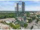 Stunning exterior view of modern high-rise condominium building with glass facade and surrounding greenery at 3630 Peachtree Ne Rd # 3302, Atlanta, GA 30326