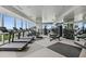 Modern gym area featuring treadmills, weights, machines, mirrors, and floor-to-ceiling windows with stunning views at 3630 Peachtree Ne Rd # 3302, Atlanta, GA 30326