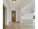 Hallway view with beamed ceilings leading into a naturally lit open floorplan at 3630 Peachtree Ne Rd # 3302, Atlanta, GA 30326
