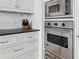 White kitchen with stainless steel appliances, including a Viking microwave, oven, and warming drawer at 3630 Peachtree Ne Rd # 3302, Atlanta, GA 30326