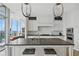 Bright kitchen showcases a center island with seating, white cabinetry and marble backsplash at 3630 Peachtree Ne Rd # 3302, Atlanta, GA 30326