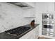 Close up of a white gourmet kitchen featuring stainless steel appliances and tiled backsplash at 3630 Peachtree Ne Rd # 3302, Atlanta, GA 30326