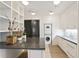 Bright laundry room with modern appliances, storage, sink and wood floors at 3630 Peachtree Ne Rd # 3302, Atlanta, GA 30326