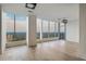Open living room featuring hardwood floors, floor-to-ceiling windows, and a modern light fixture at 3630 Peachtree Ne Rd # 3302, Atlanta, GA 30326
