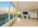 Spacious living room with floor-to-ceiling windows showcasing stunning city views at sunset at 3630 Peachtree Ne Rd # 3302, Atlanta, GA 30326