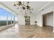 Open living area with herringbone flooring, unique light fixtures, and floor-to-ceiling windows at 3630 Peachtree Ne Rd # 3302, Atlanta, GA 30326