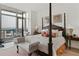 Elegant main bedroom with a four-poster bed, sitting area, and floor-to-ceiling windows with city views at 3630 Peachtree Ne Rd # 3302, Atlanta, GA 30326