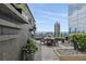 Charming outdoor rooftop terrace featuring stone accents, plants, dining furniture and fantastic skyline views at 3630 Peachtree Ne Rd # 3302, Atlanta, GA 30326