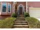 Inviting front entrance with stone steps, mature landscaping, and an arched doorway at 3720 Harts Pl, Atlanta, GA 30341