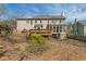 Exterior view of the home showcasing a spacious backyard, deck, and sunroom at 820 Hounds Ridge Ct, Lawrenceville, GA 30043