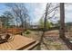 View of the backyard area with a patio, trees, and privacy fence, offering serene outdoor living at 820 Hounds Ridge Ct, Lawrenceville, GA 30043