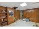 Basement with wood paneling, providing flexible space with built-in shelving for storage at 820 Hounds Ridge Ct, Lawrenceville, GA 30043