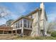 Exterior shot showcasing a sunroom, a deck, and the architectural details of the home at 820 Hounds Ridge Ct, Lawrenceville, GA 30043