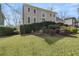 Exterior facade of a home with a manicured front lawn and mature bushes at 820 Hounds Ridge Ct, Lawrenceville, GA 30043